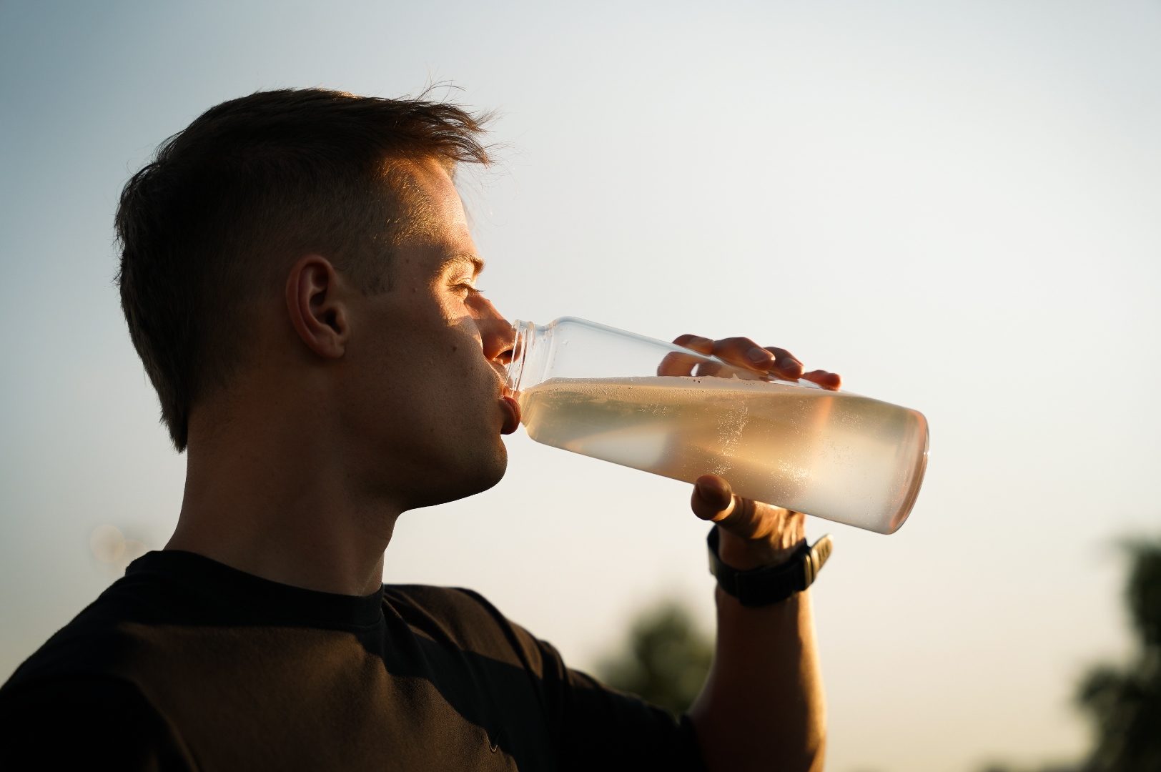 Athlete hydrating at sunset