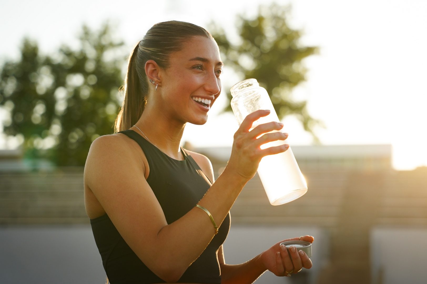 Athlete hydrating at golden hour